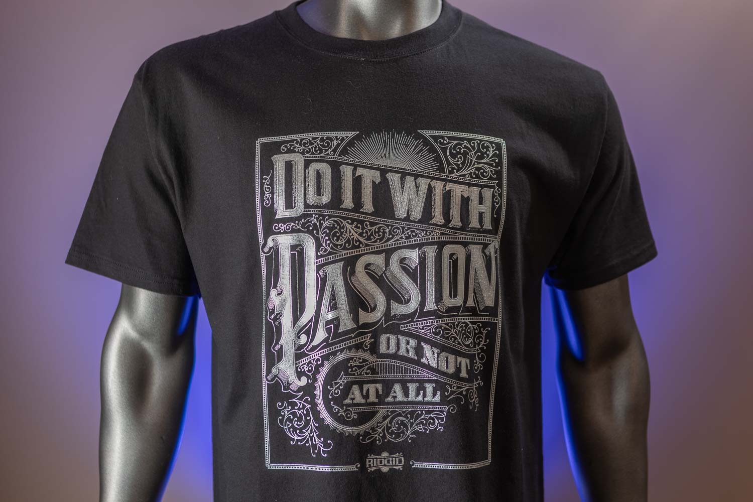 “Do it with passion or not at all” printed in matte silver foil with intricate detailing on a dark garment